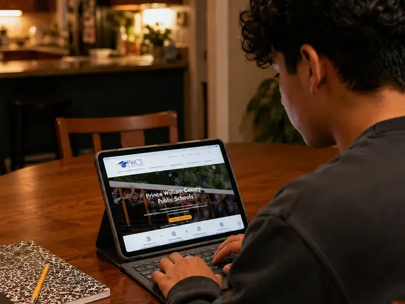 Student using an iPad at the kitchen table